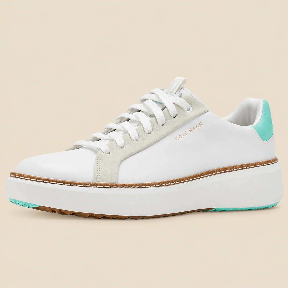 Cole Haan GrandPro Topspin Golf Sneakers — side view on cream background