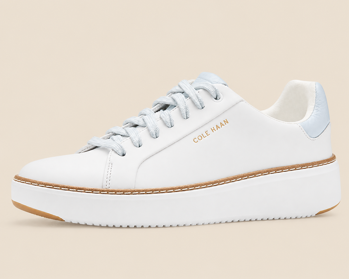 Cole Haan GrandPro Topspin Court Sneakers — side view on cream background