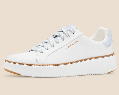Cole Haan GrandPro Topspin Court Sneakers — side view on cream background