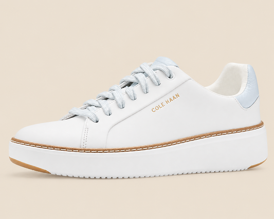 Cole Haan GrandPro Topspin Court Sneakers — side view on cream background