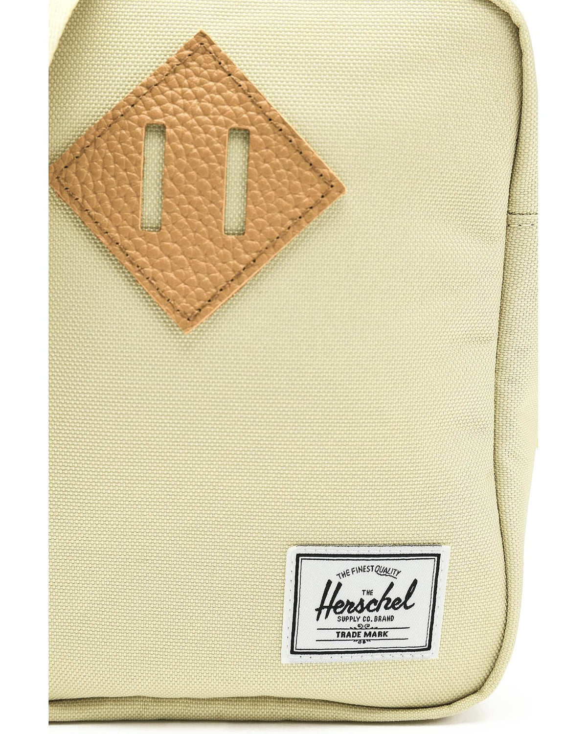 Herschel Heritage Crossbody — leather patch and logo detail